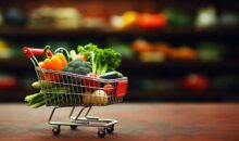 Supermarket shopping cart full of fresh vegetables and fruits, healthy organic food concept on blurred nature background with copy space. Eco friendly, vegan,vegetarian concept